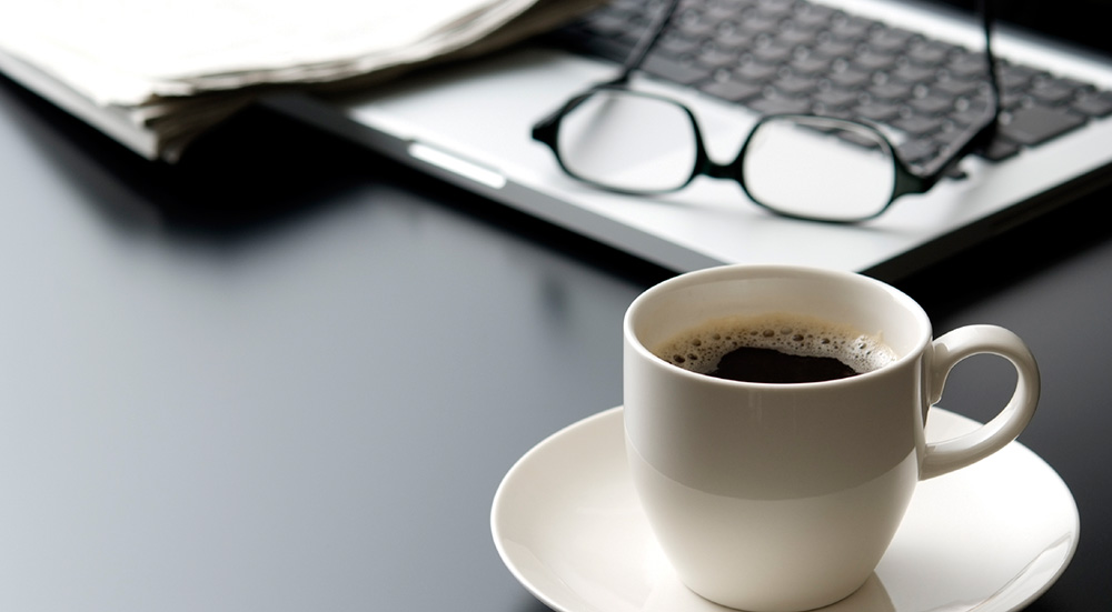 Coffee, writing desk, computer